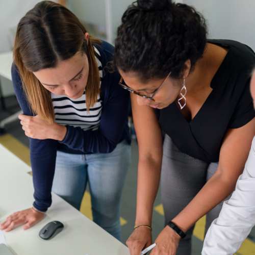 Two women collaborating on a project.